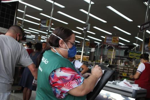 fiscal anota em prancheta dentro de mercado #paratodosverem 