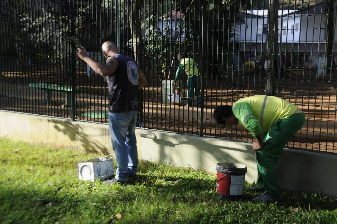 homem pintam mureta na praça. #paratodosverem