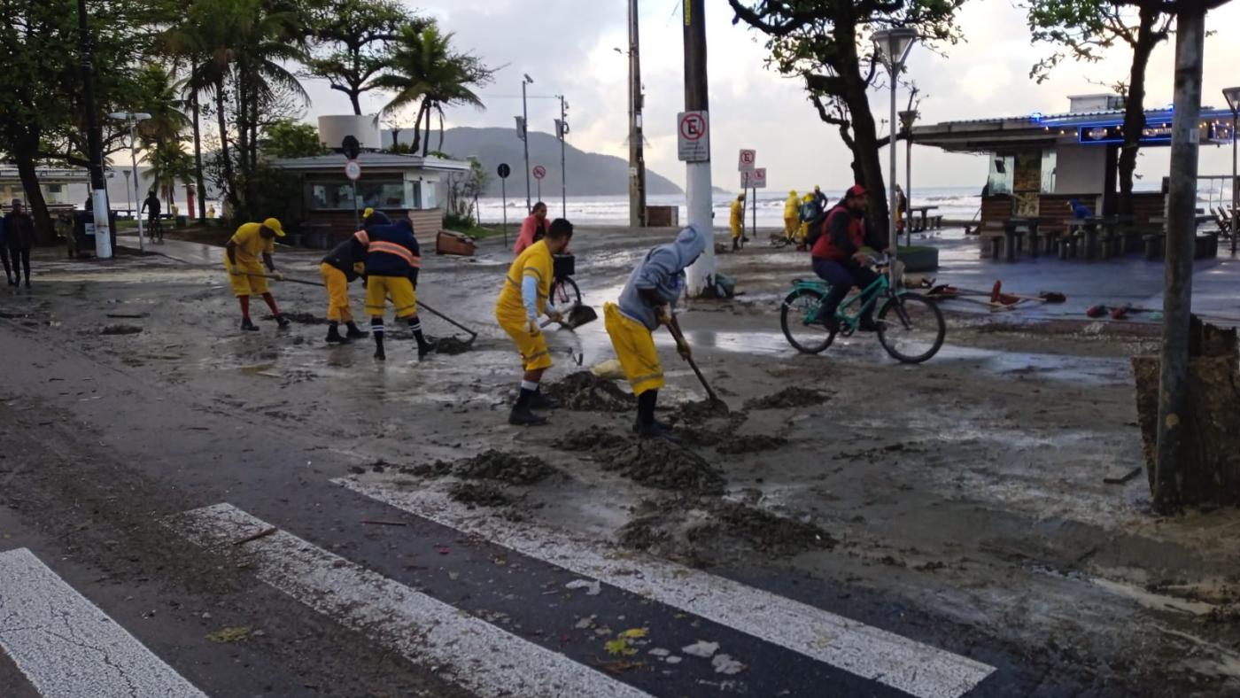 homens varrem excesso de areia que chegou à avenida trazida pela maré. #paratodoverem