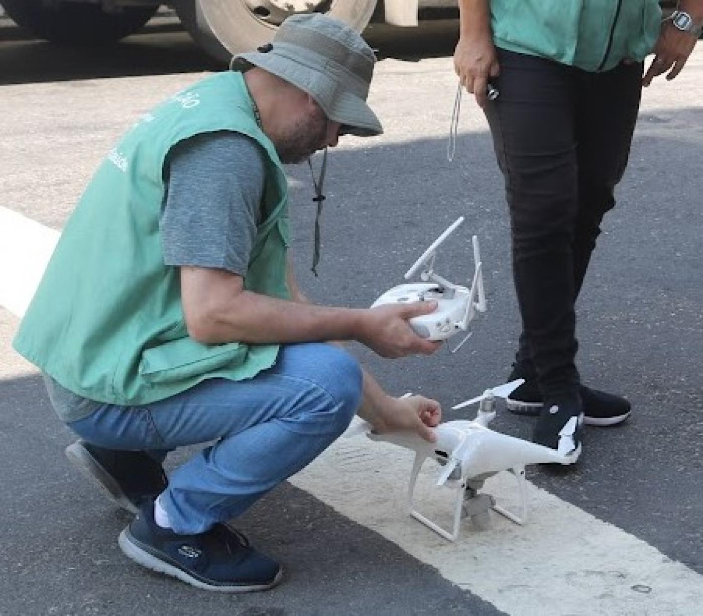 rapaz manipula drone no chão #paratodosverem