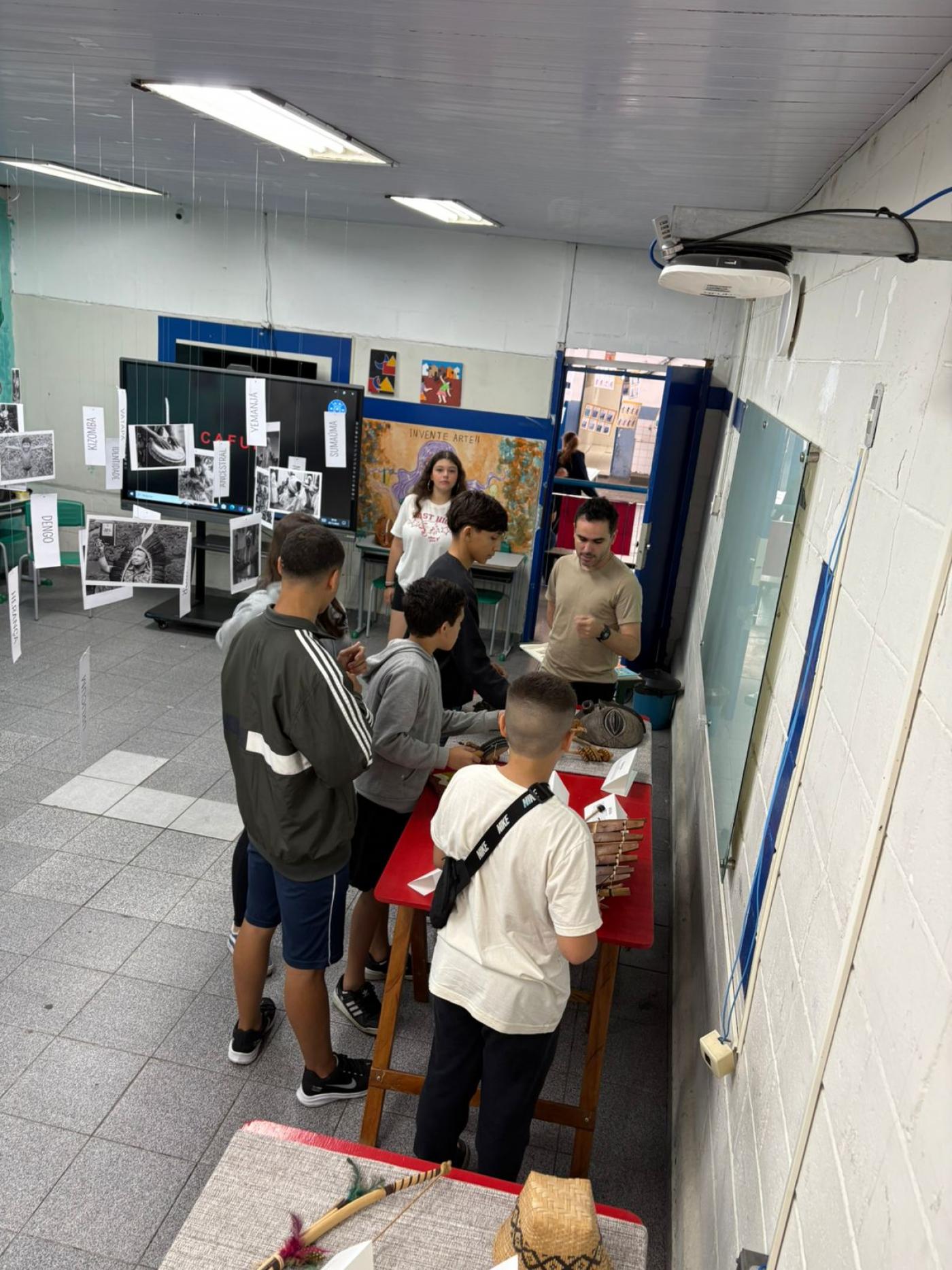 alunos olhando trabalhos na feira #paratodosverem