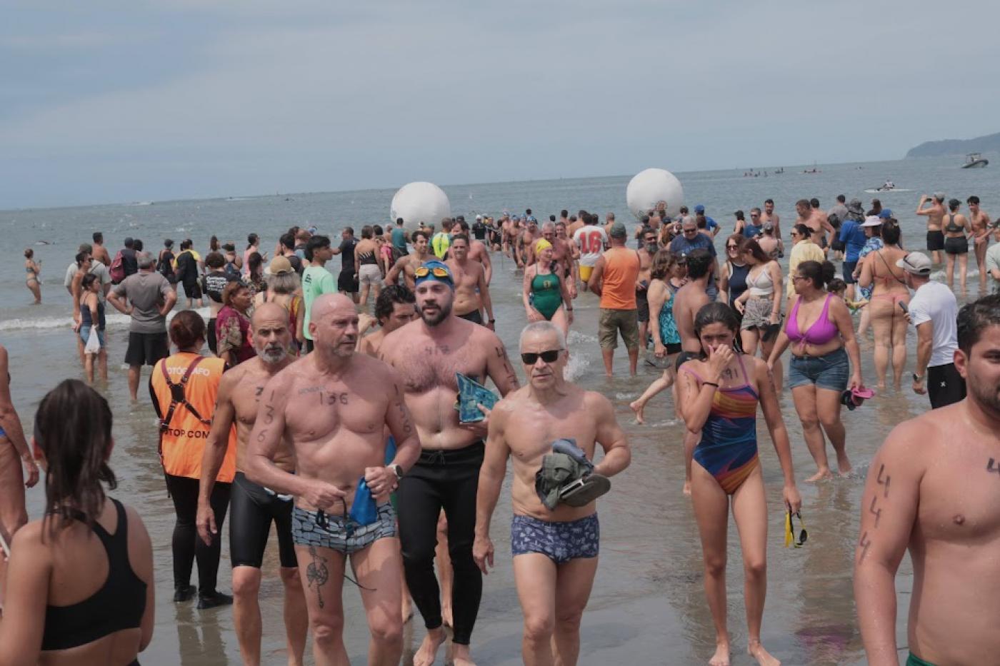 pessoas com toca saindo do mar #paratodosverem