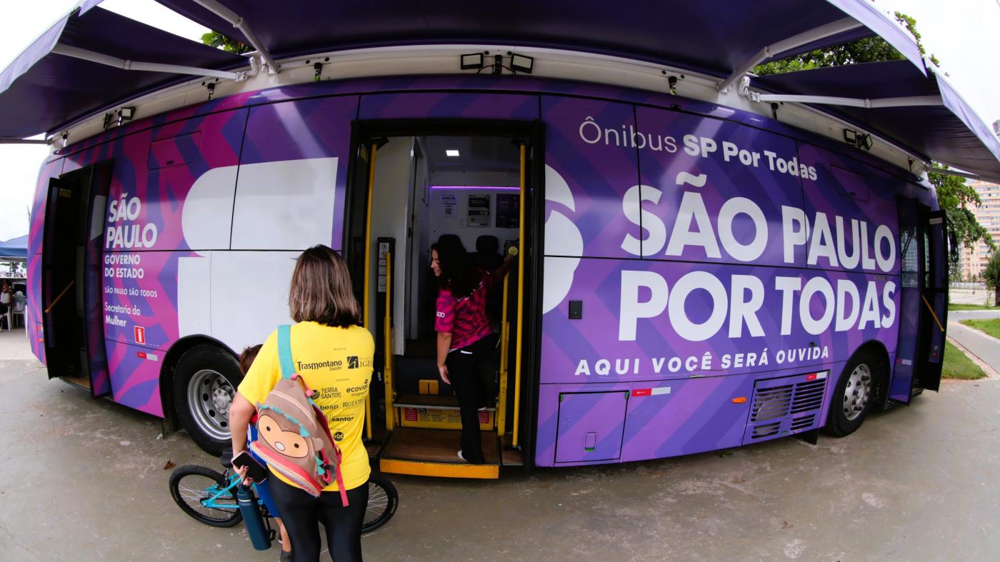 ônibus com porta aberta e duas mulheres na frente. #paratodosverem