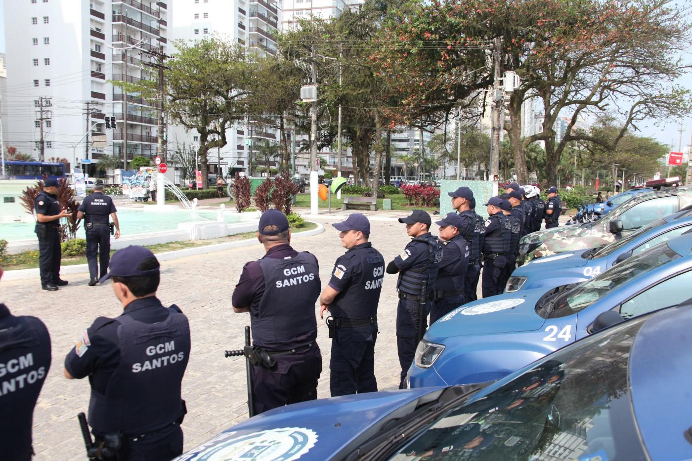 guardas municipais na orla enfileirados diante de viaturas. #paratodosverem