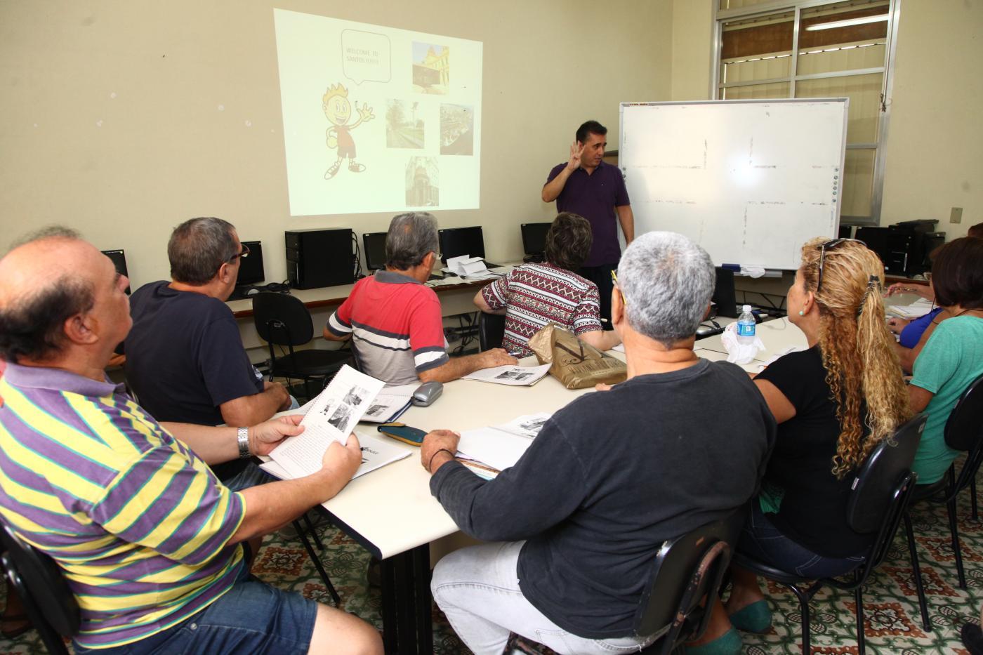 professor dá aula e alunos sentados observam #paratodosverem