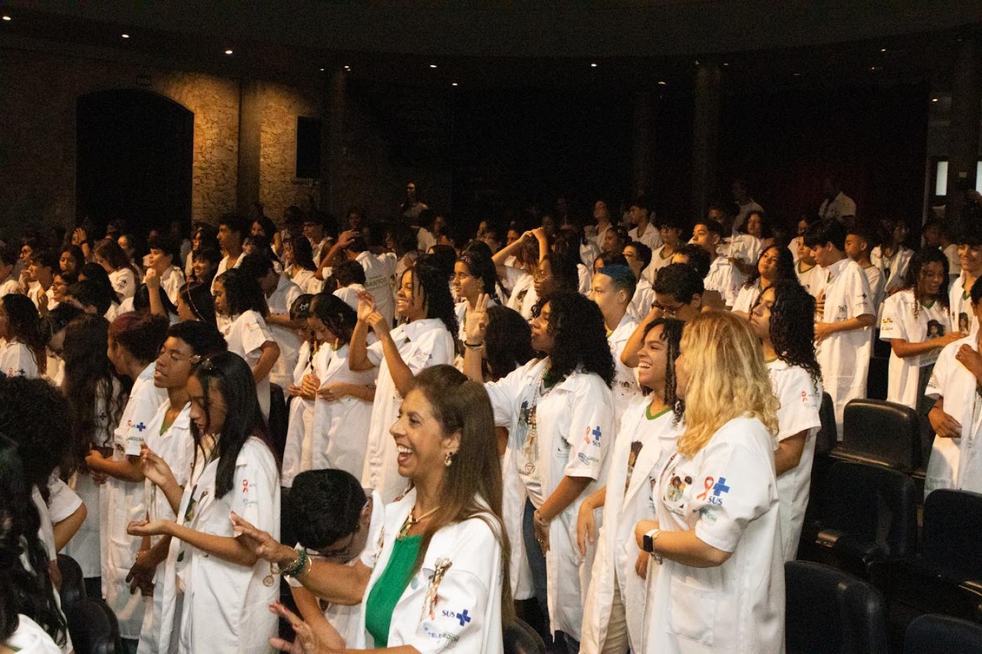 alunos do programa de jaleco no auditório #paratodosverem 