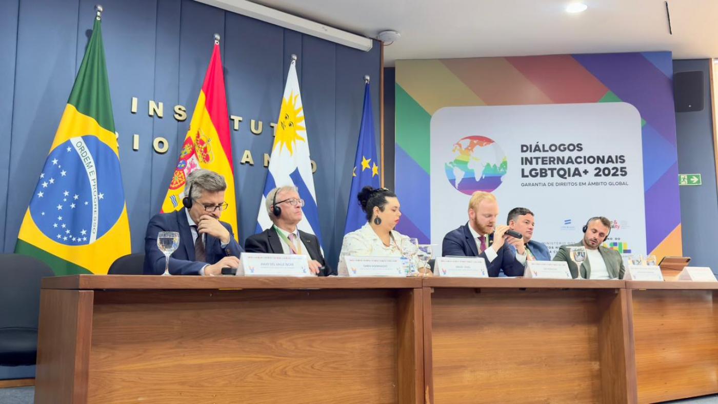 pessoas em mesa de seminário #paratodosverem