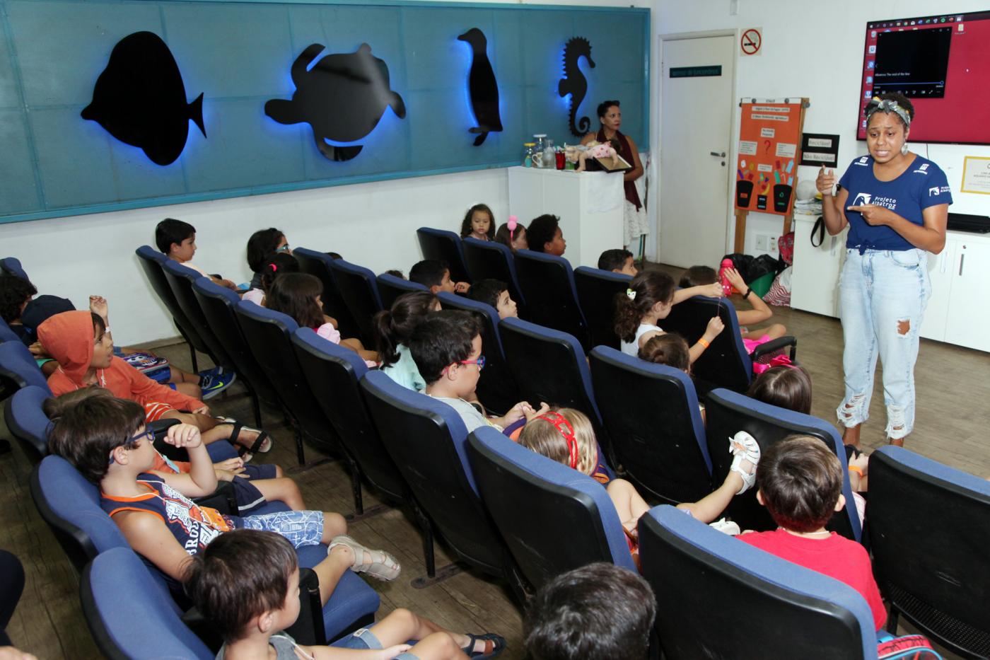 crianças assistem a palestra no auditório #pracegover 