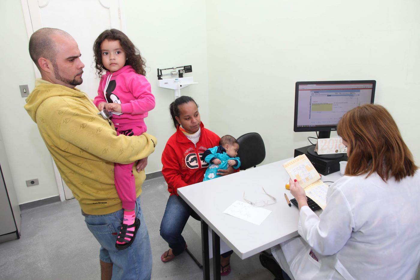 médica atende família em unidade de saúde #pracegover 