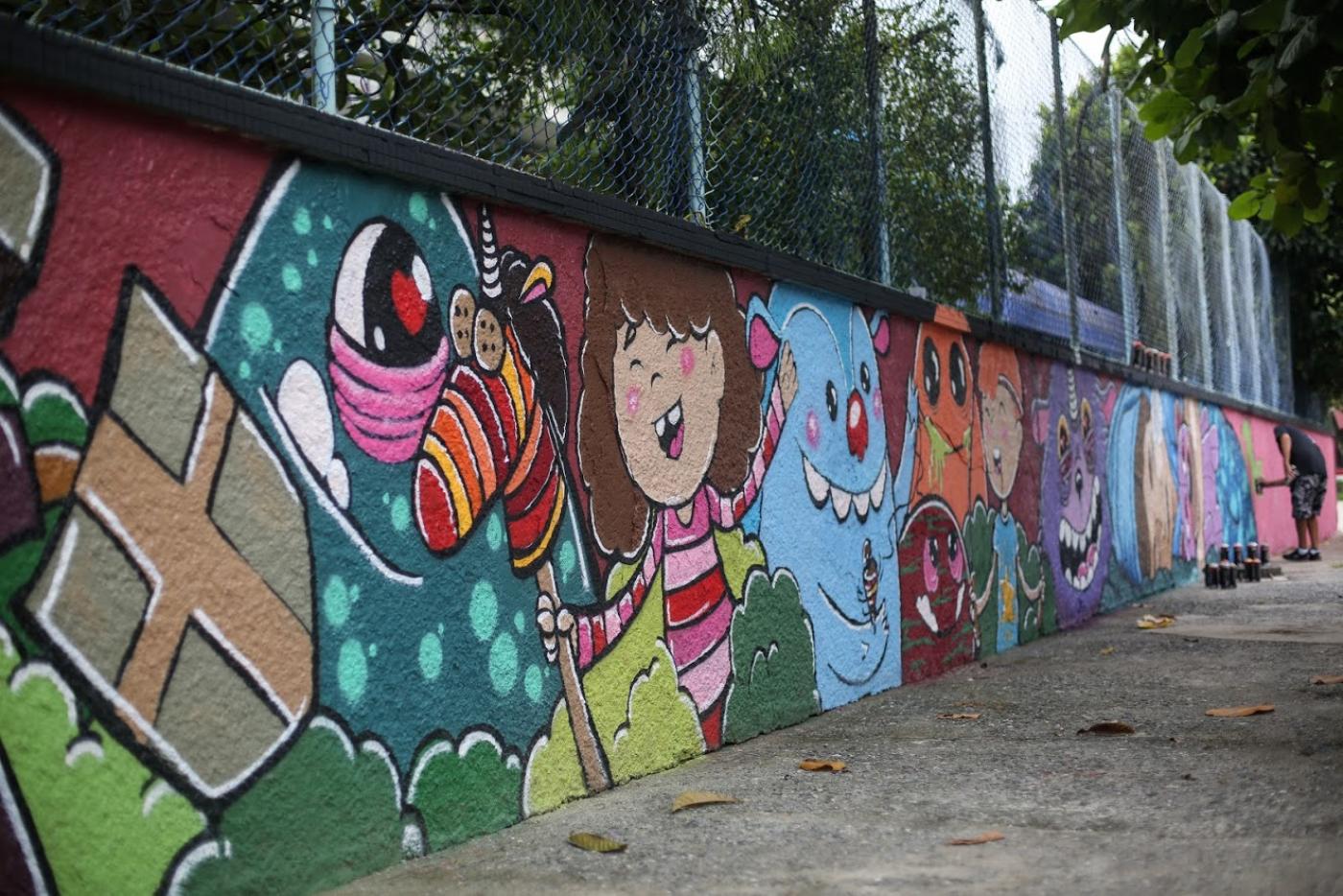 Vista geral de muro todo colorido com motivos infantis. #Paratodosverem