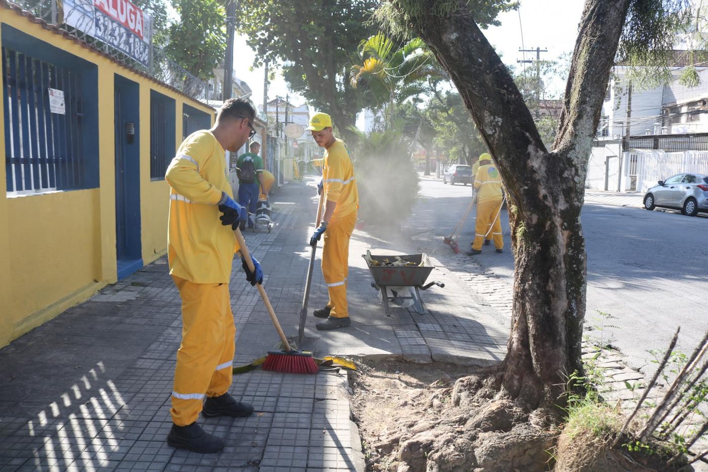 homens varrem rua após raspação de calçadas. #paratodosverem