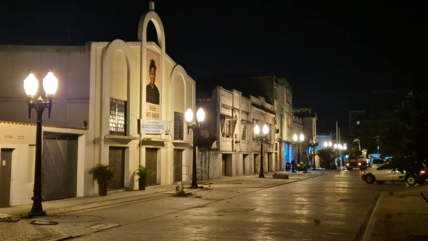 rua à noite iluminada com postes decorativos #paratodosverem