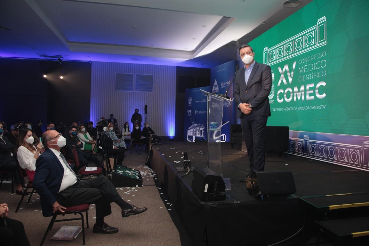 O prefeito Rogério Santos em tribuna no evento. #paratodosverem