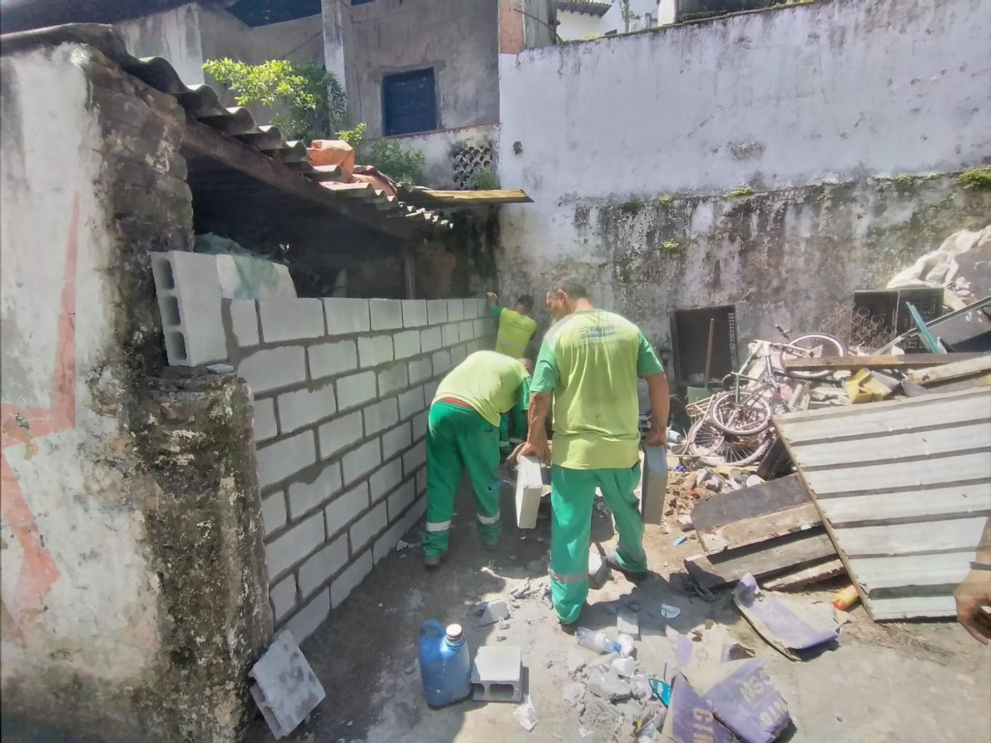homens fecham entrada do imóvel com blocos de concreto #paratodosverem