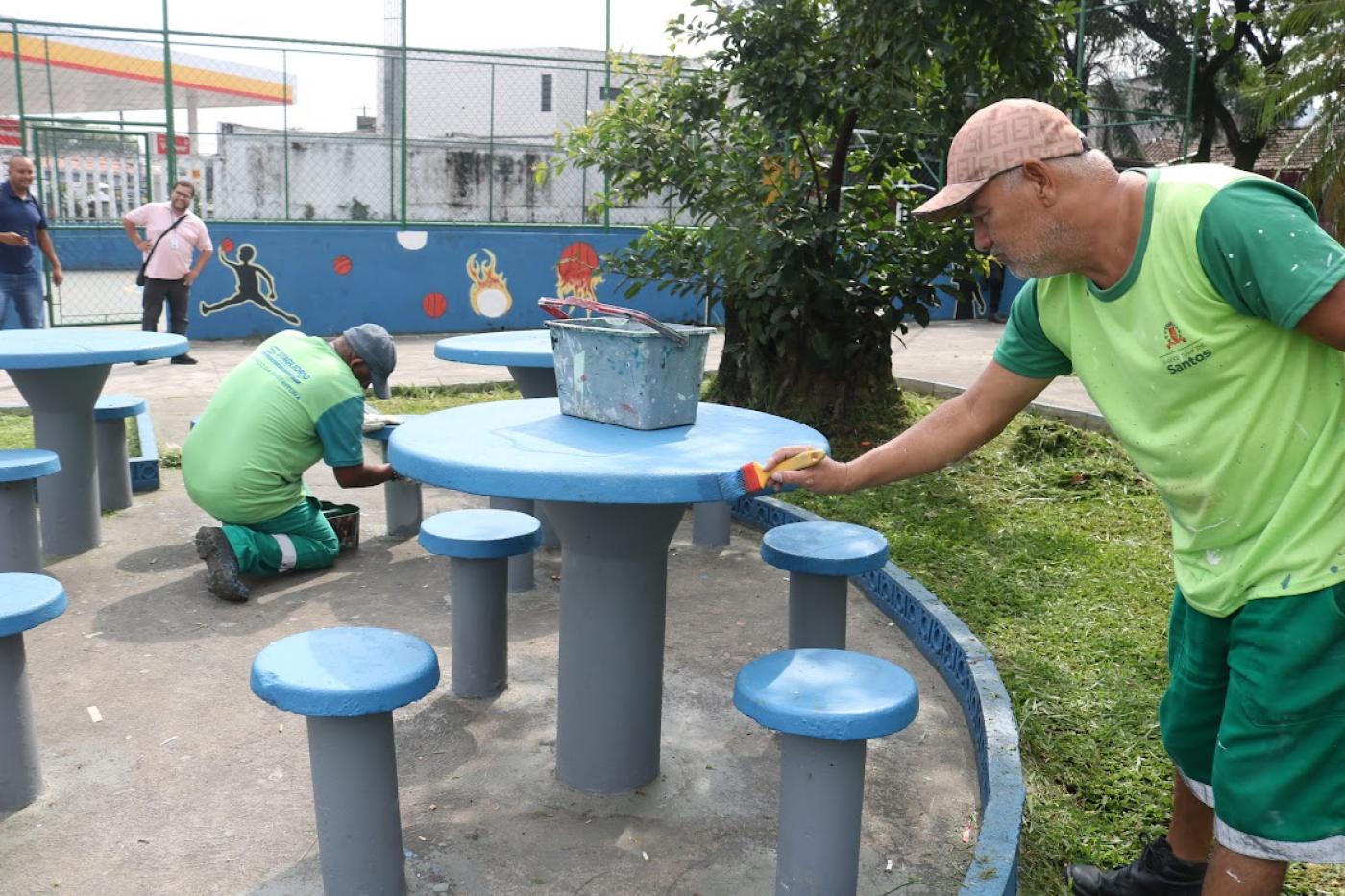 operários pintando praça #paratodosverem