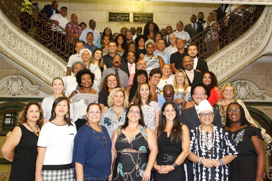 Diversas pessoas posam para foto em escadaria de hall da prefeitura. #Pracegover