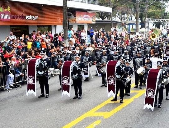 banda está desfilando em avenida. #paratodosverem