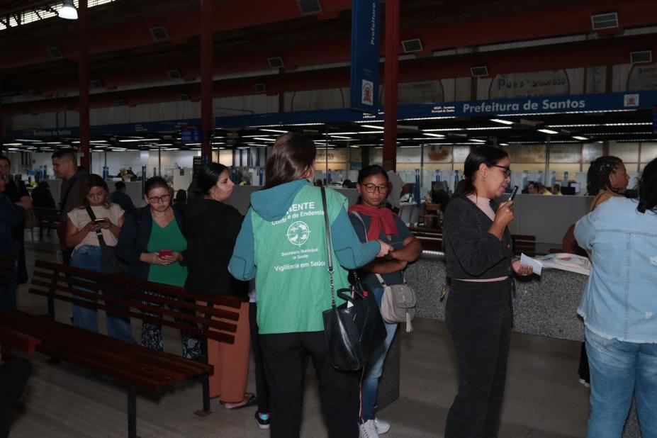 agente entrega panfletos na fila #paratodosverem 