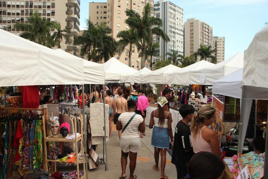pessoas olhando produtos em feira #paratodosverem