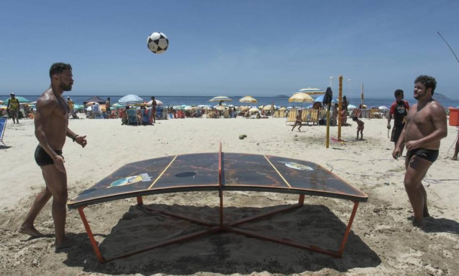 Jogadores na praia praticam  o esporte #paratodosverem