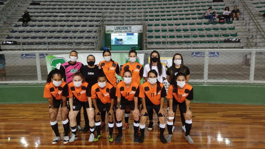 Meninas do futsal posando para foto no ginásio #paratodosverem