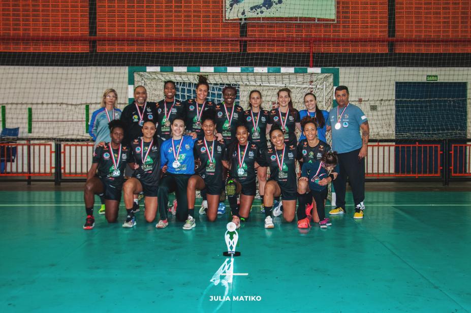 atletas posam para foto com medalha em quadra #paratodosverem