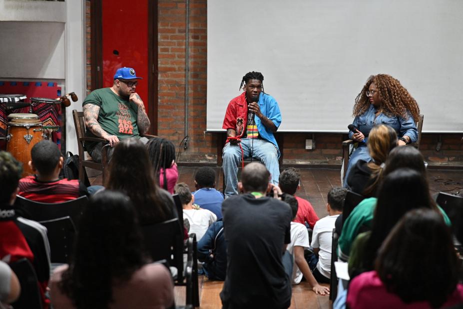 jovens reunidos em auditório assistem palestra. #paratodosverem
