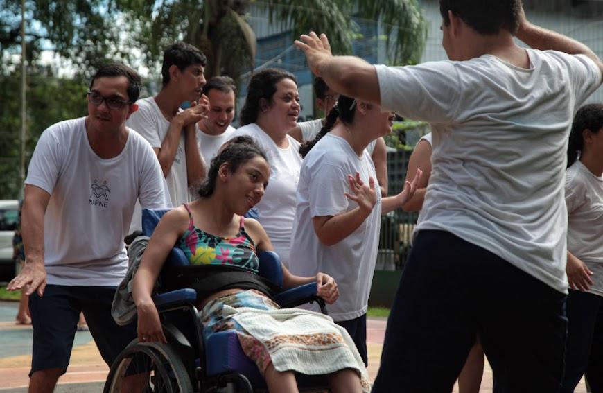 jovens com deficiência e uma em cadeira de rodas dançam animados. #paratodosverem