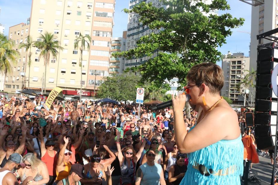 cantora com microfone na frente do público #paratodosverem