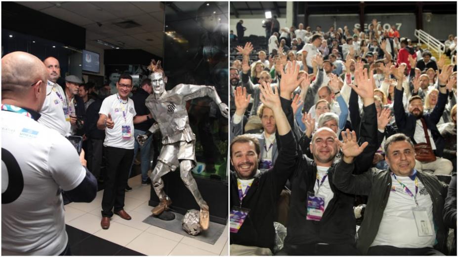 visitante tira foto com estatua e pessoas da comitiva de mãos levantadas no estádio #paratodosverem