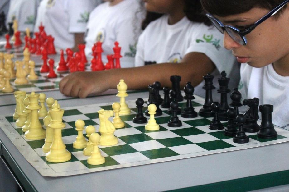 close de criança pensando diante de tabuleiro. #paratodosverem 