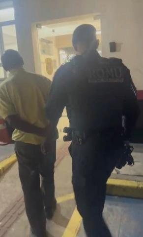 guarda conduz homem de costas para a foto. #paratodosverem