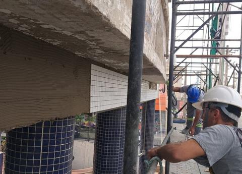 operários instalando revestimento #paratodosverem 